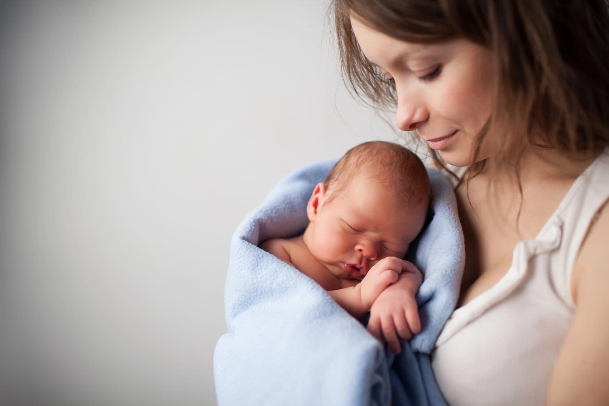 Mother with sleeping newborn baby